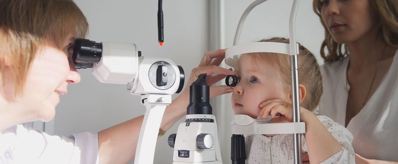 A doctor examining a child's eye