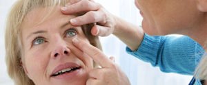An elderly woman is undergoing eye check up