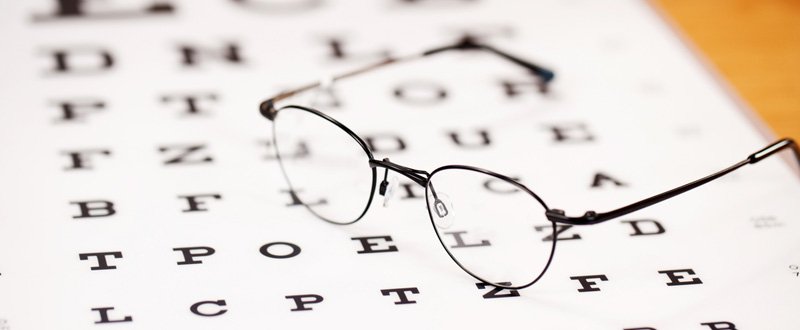 Snellen chart and eye glasses on top of it