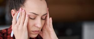 Woman suffering from headache behind eyes